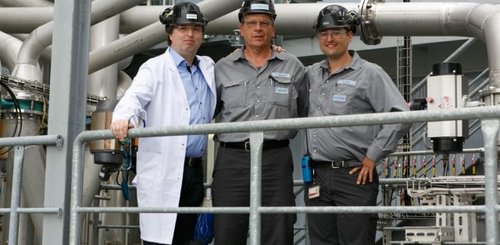 Three team colleagues at Industriepark Höchst in Frankfurt wearing black safety helmets.
